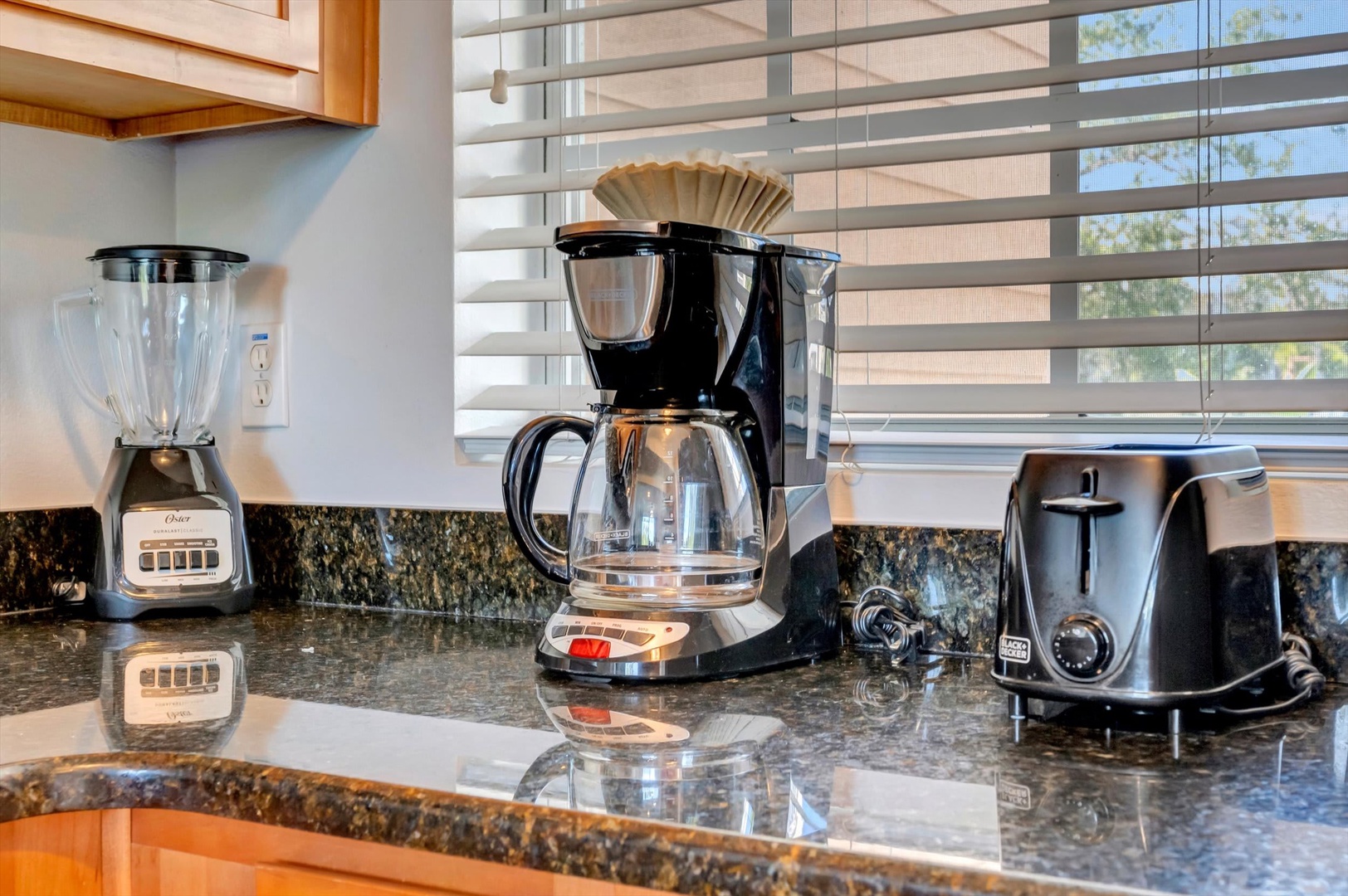 Start your mornings right with a full coffee setup on gleaming granite counters. Brew your favorite blend, enjoy natural light streaming in, and settle into your vacation rhythm.