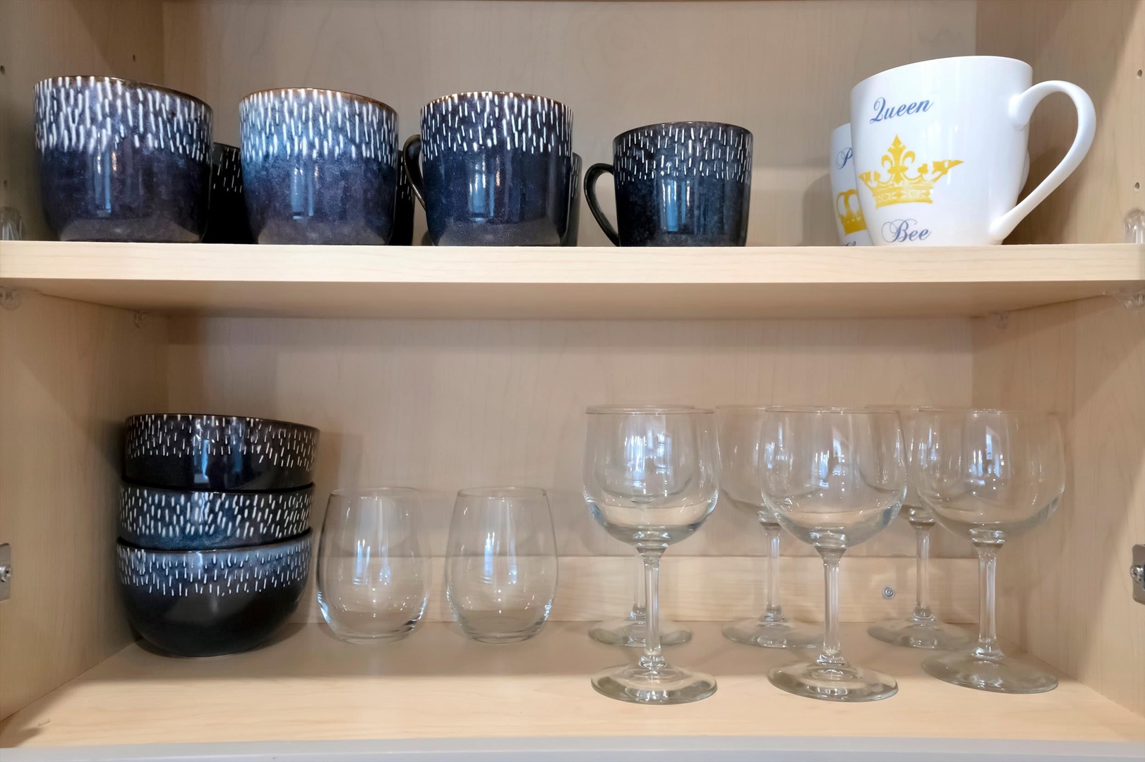 Your cupboard is stocked with everything you need for morning coffee or evening wine—charming mugs, stemware, and tumblers await your arrival.