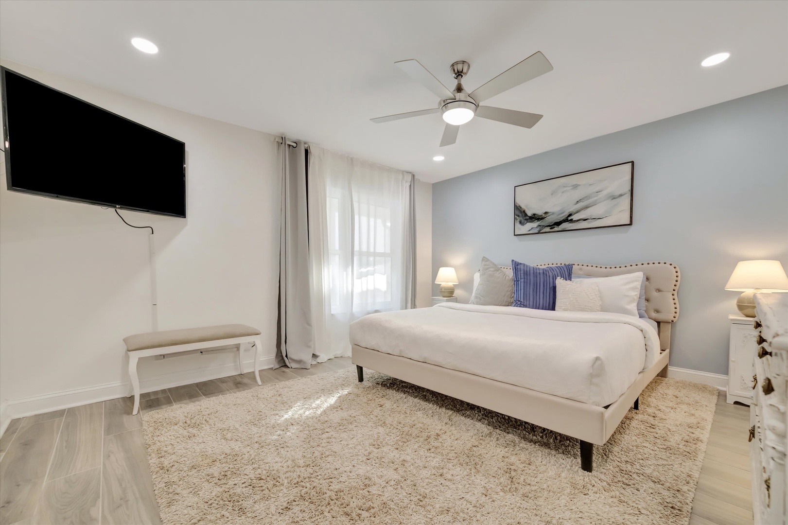 Unwind in your serene bedroom retreat with plush bedding and modern amenities. Sink into the comfortable bed after a day of adventure, enjoy your favorite shows, and stay cool with the ceiling fan overhead.