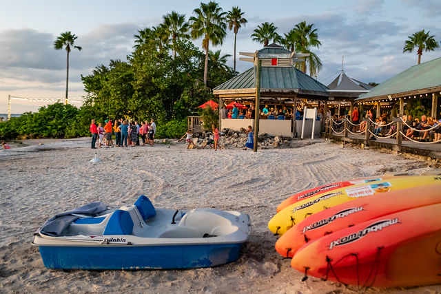 Sandy shores and water activities await at this beachfront property surrounded by lush tropical palms and casual dining options.
