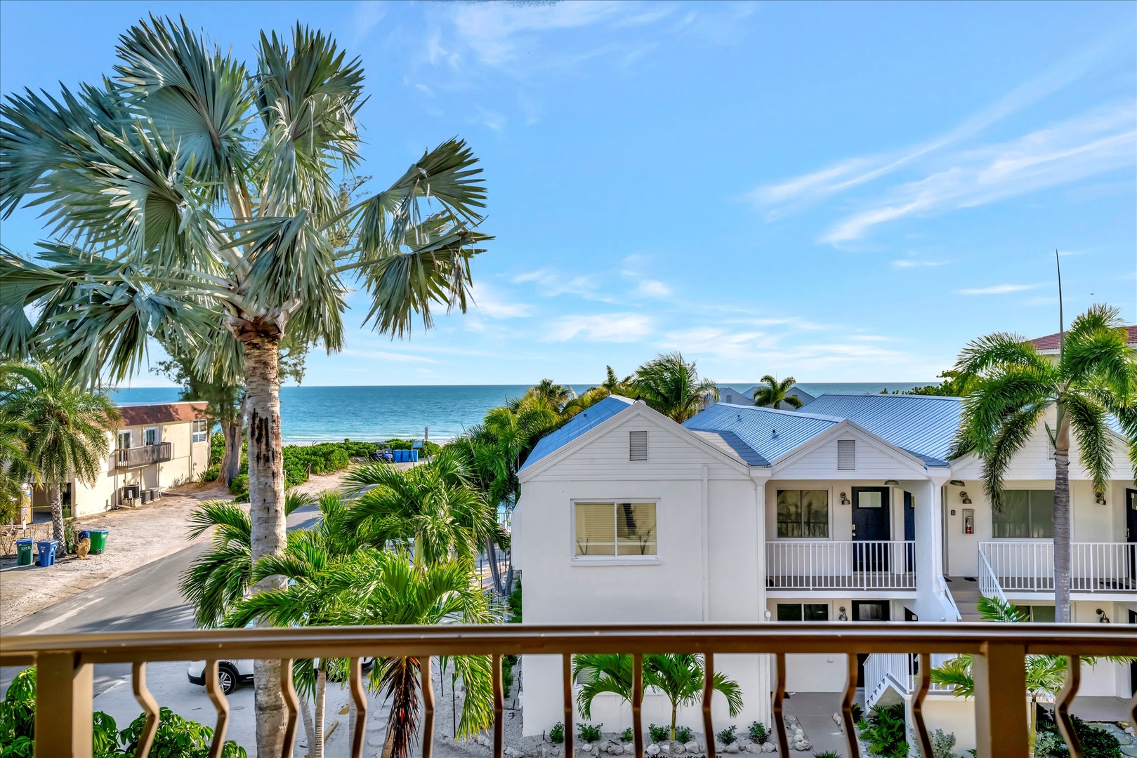 This waterfront retreat sits steps from the ocean, surrounded by swaying palms and turquoise horizons. The balcony offers serene water and street views—perfect for morning coffee or sunset-watching.