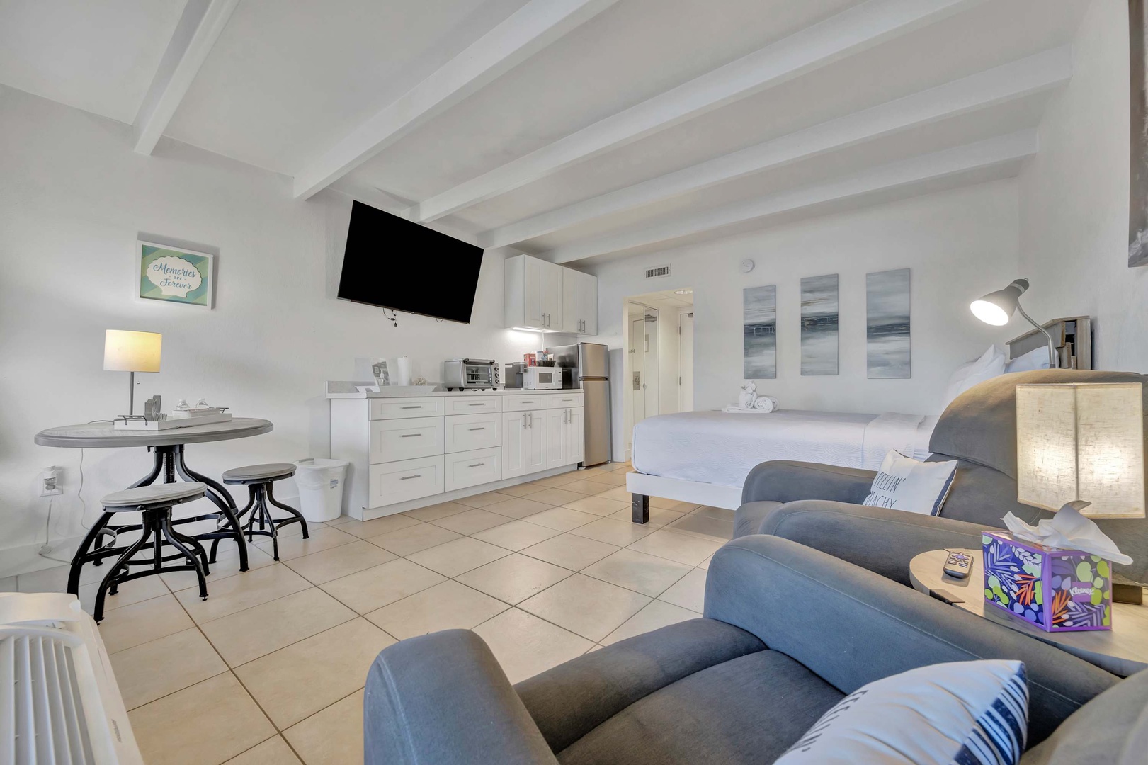Your bright, open studio blends rest and relaxation with sleek modern comfort, offering a cozy sitting area, fully equipped kitchenette, and two plush beds for restful nights.