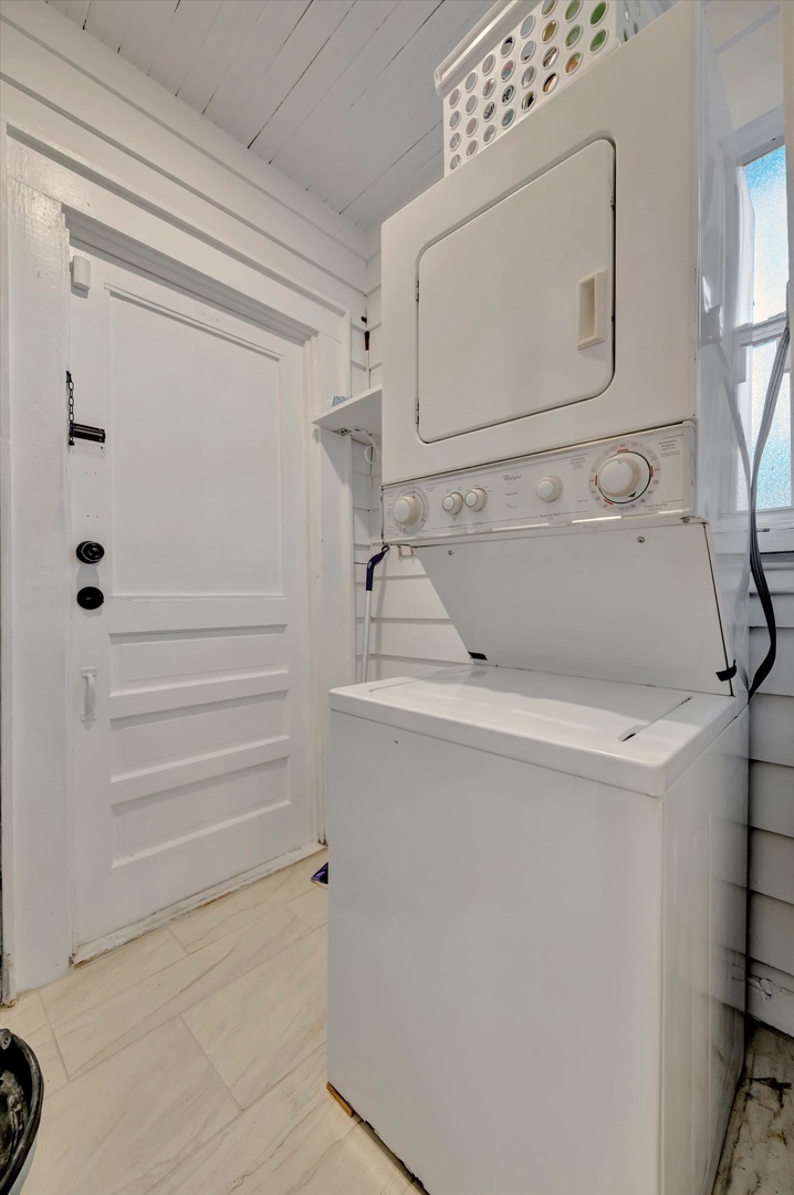 All-in-one washer and dryer combo keeps your wardrobe fresh throughout your stay, tucked neatly into this bright space with a handy laundry basket above.