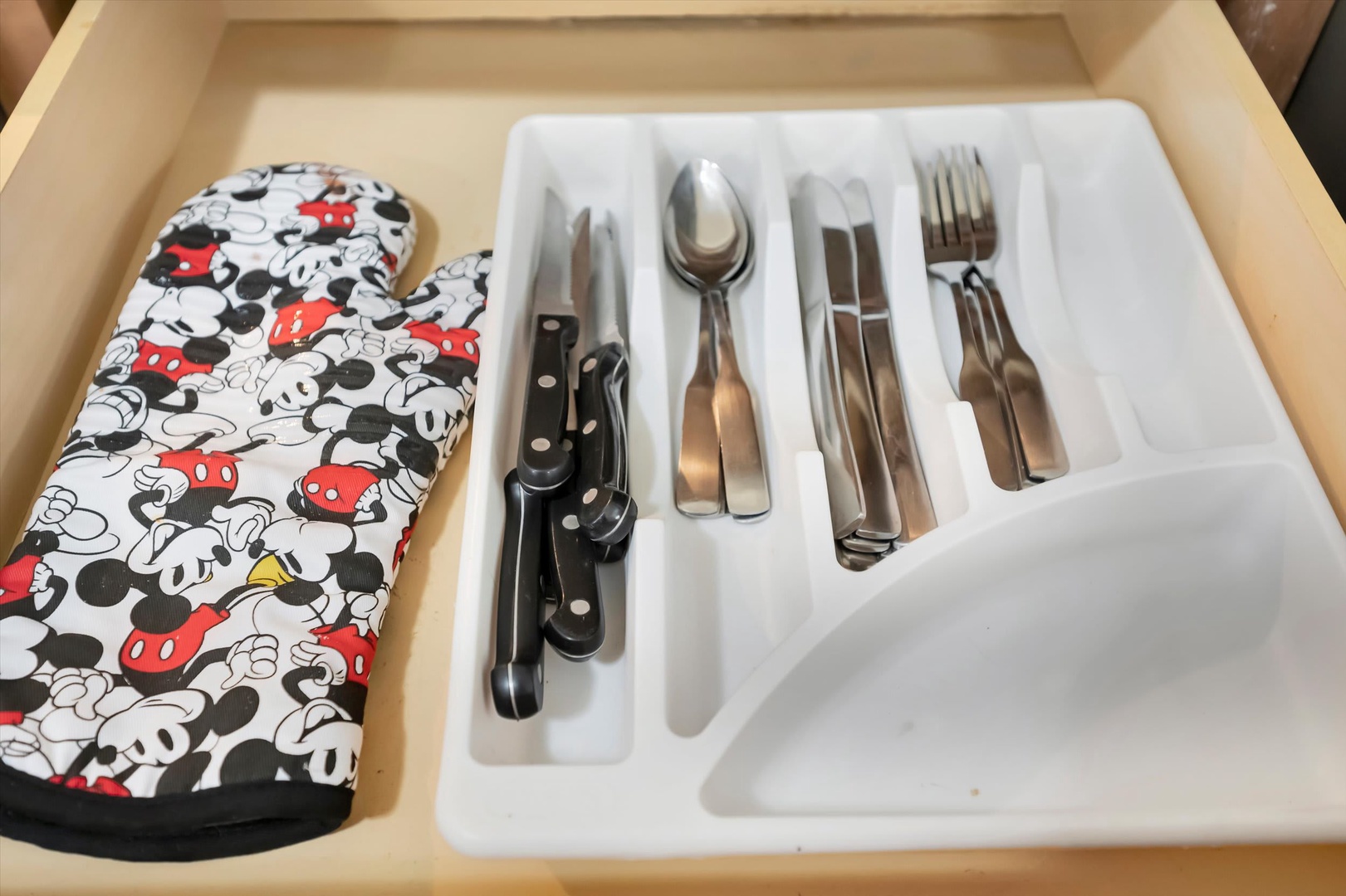 Your fully equipped kitchen includes quality silverware, a can opener, and even a playful oven mitt to make meal prep feel like home.