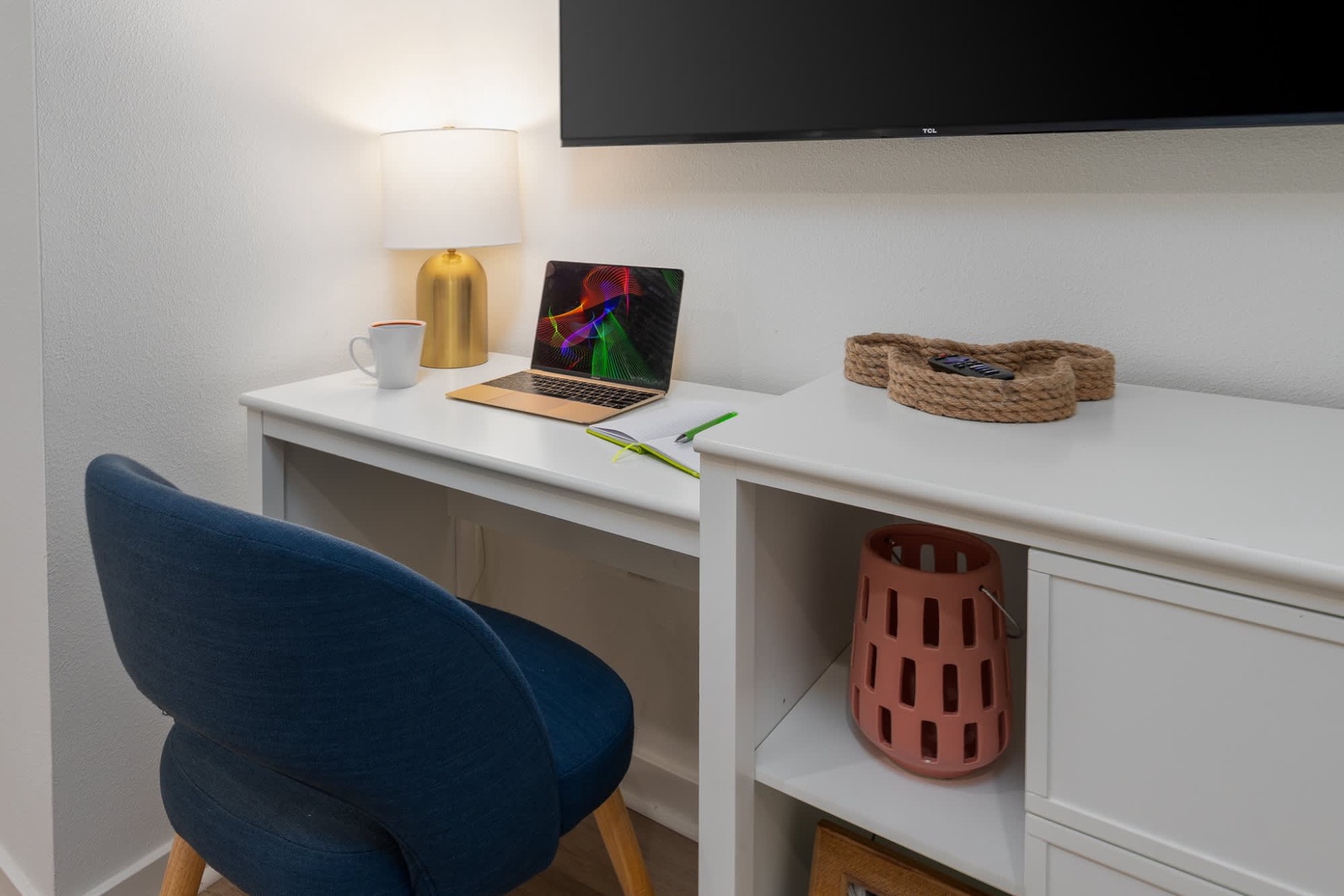 Your dedicated workspace features a clean white desk, modern chair, and thoughtfully placed lighting—a perfect spot to catch up on emails or plan your next adventure.