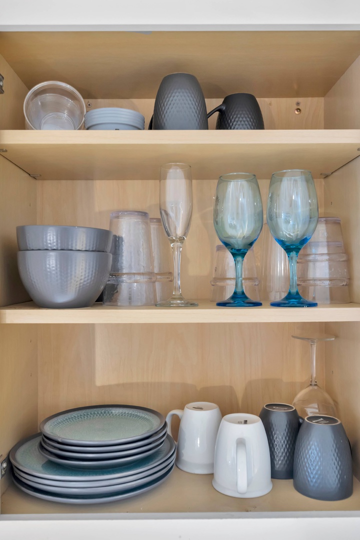 Open shelves stocked with dishes, glassware, and everything you need to feel right at home in your kitchen.