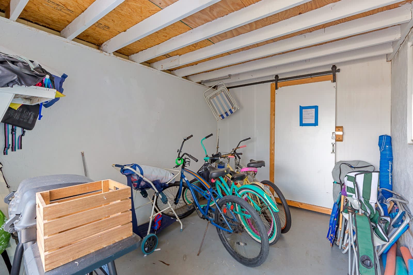 Storage area with bicycles ready for your next adventure exploring the neighborhood. Wooden ceiling beams and sliding door entry provide easy access to your gear.
