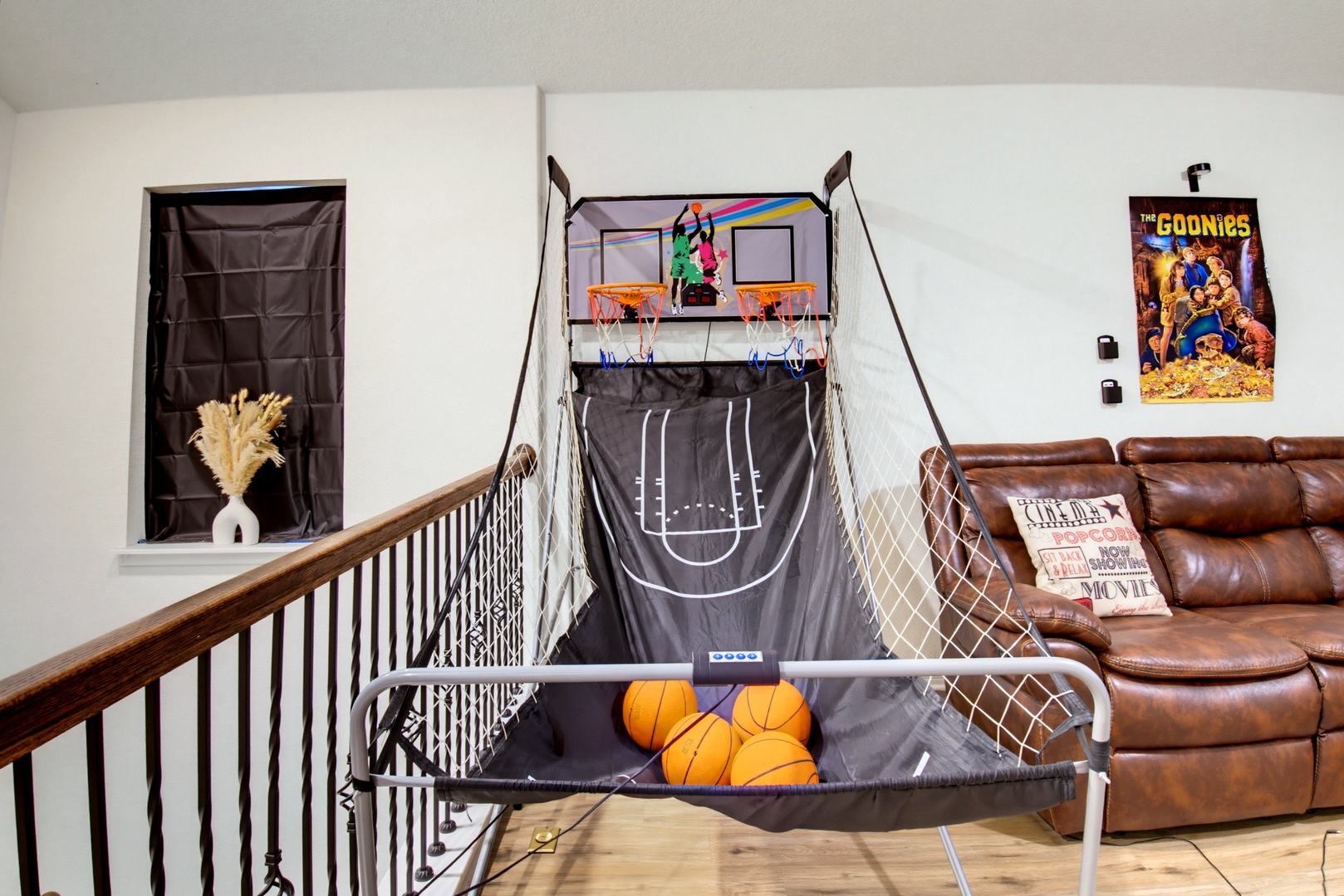 Challenge yourself to a game of hoops in your own arcade-style basketball setup, complete with scoreboard and ball return.