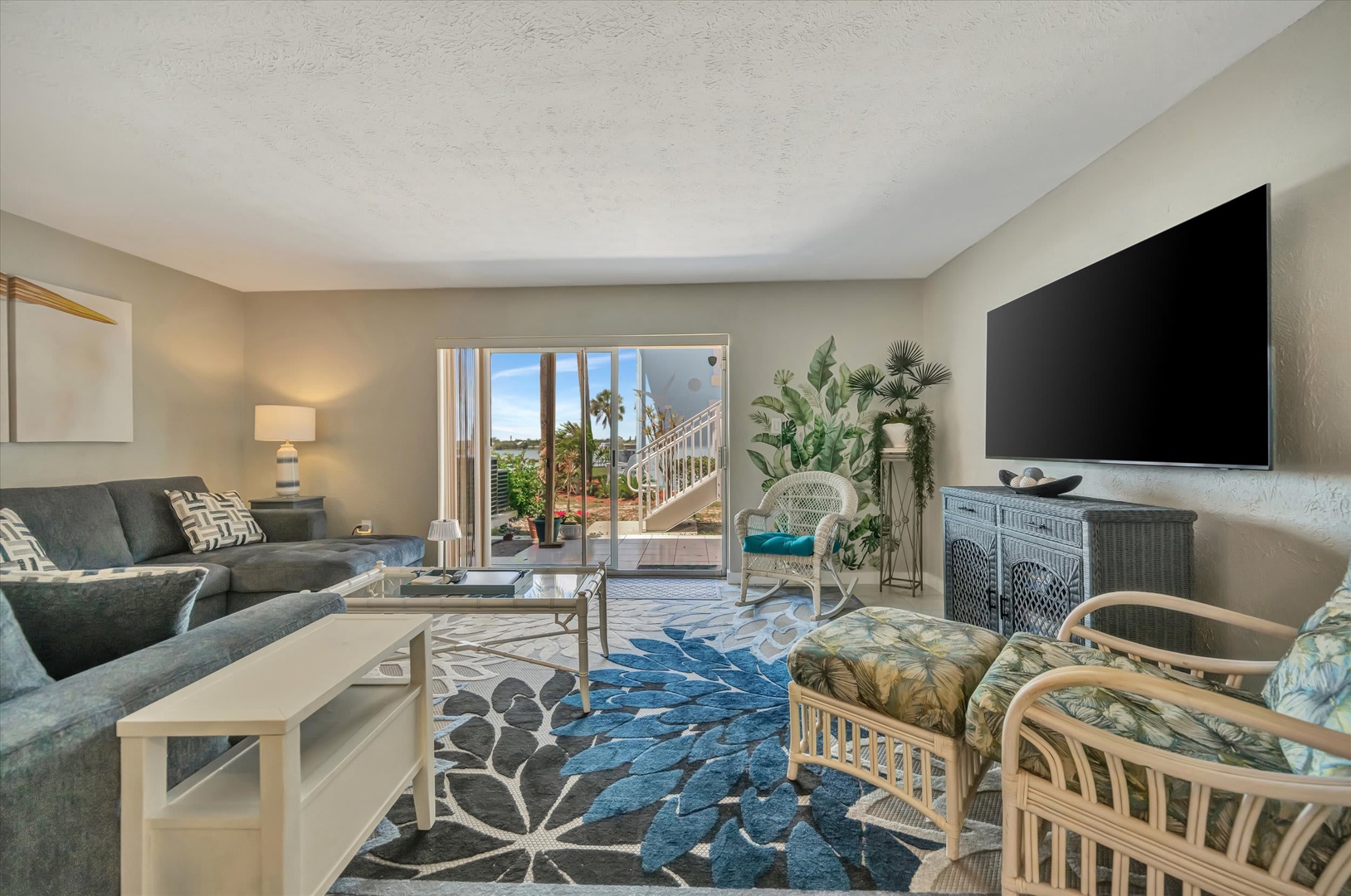Step into your bright, airy living space where comfort meets coastal charm. Sink into plush seating, catch your favorite shows, and step right out to your private patio oasis—perfect for morning coffee or evening relaxation.