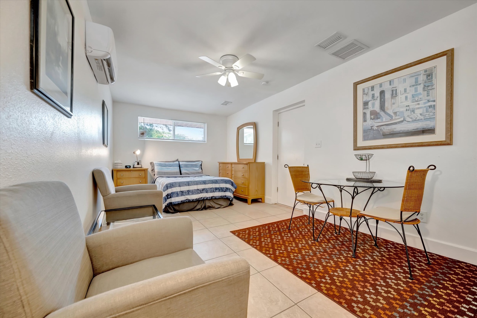 Step into your bright, open studio where crisp tile floors meet cozy comfort. Unwind on the plush sofa, dine at your intimate bistro table, and drift off in the inviting sleeping area—your relaxing retreat awaits.