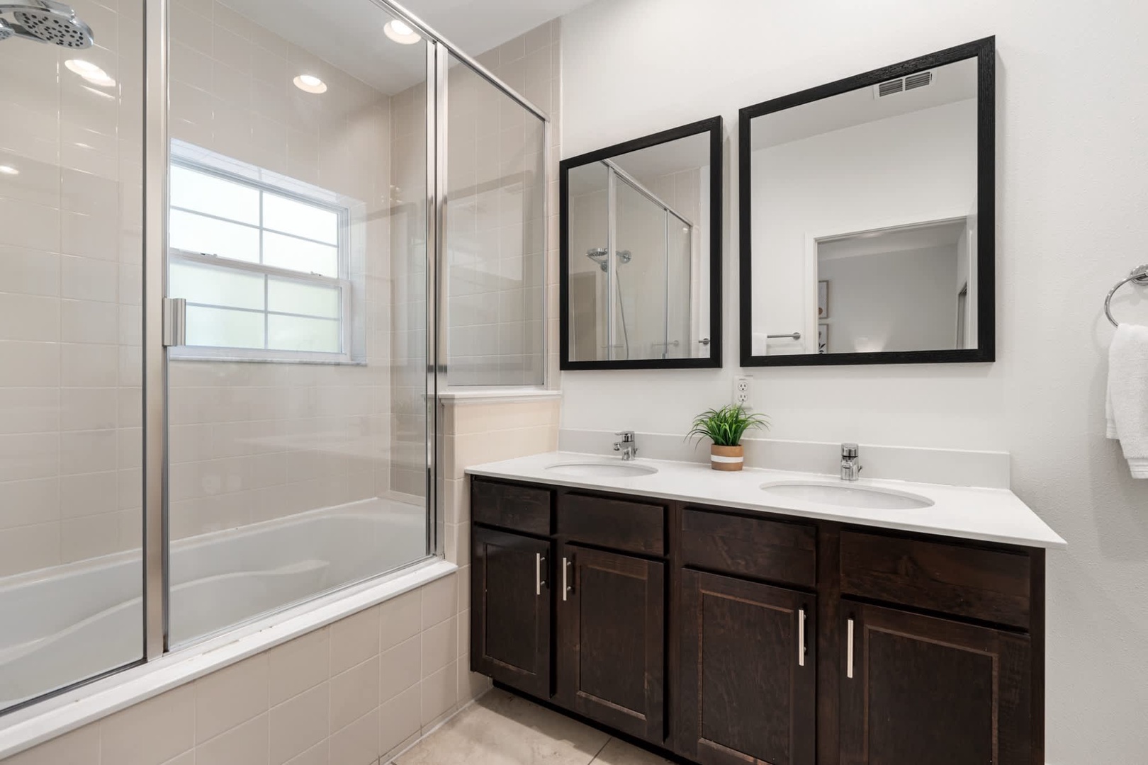 Refresh after a day of exploring in your spotless bathroom with dual sinks, a tub-shower combo, and crisp tile finishes that make every morning feel like a fresh start.