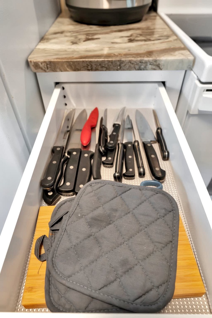 Everything you need is right at your fingertips in this thoughtfully organized kitchen, where quality knives and essentials await your culinary adventures.