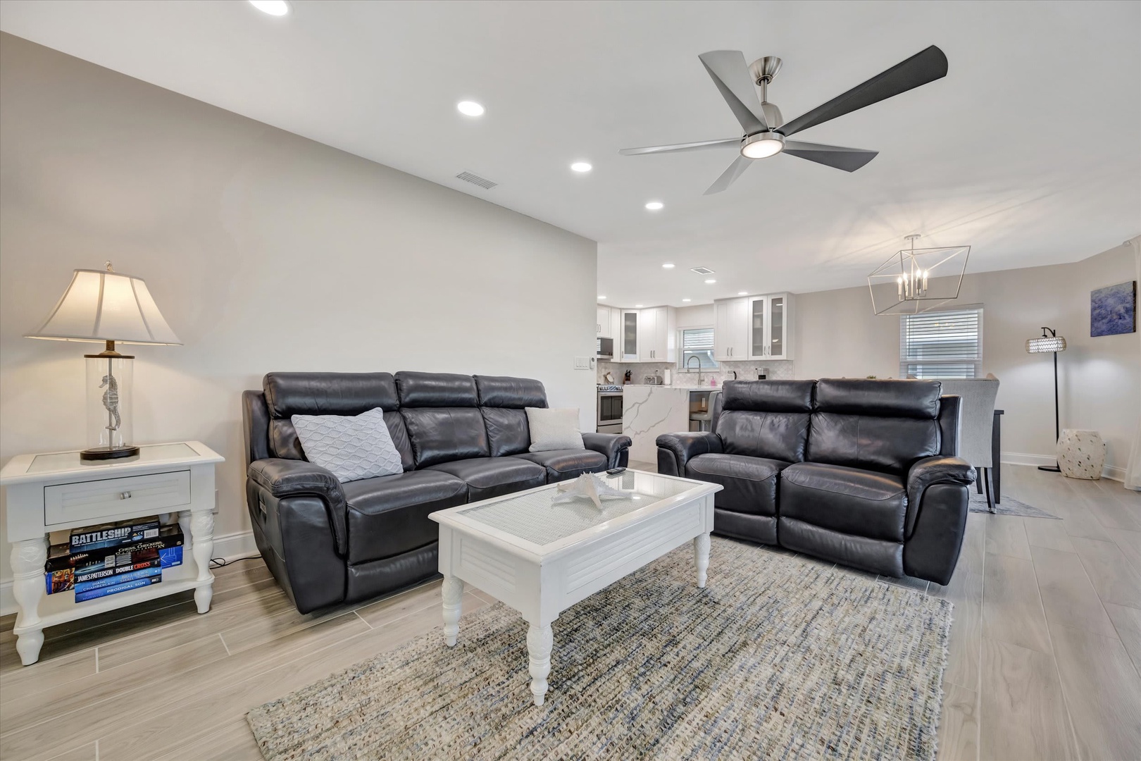 Settle into plush leather seating and enjoy an open-concept retreat where modern comfort meets coastal calm. Your ceiling fan keeps you cool while you unwind.