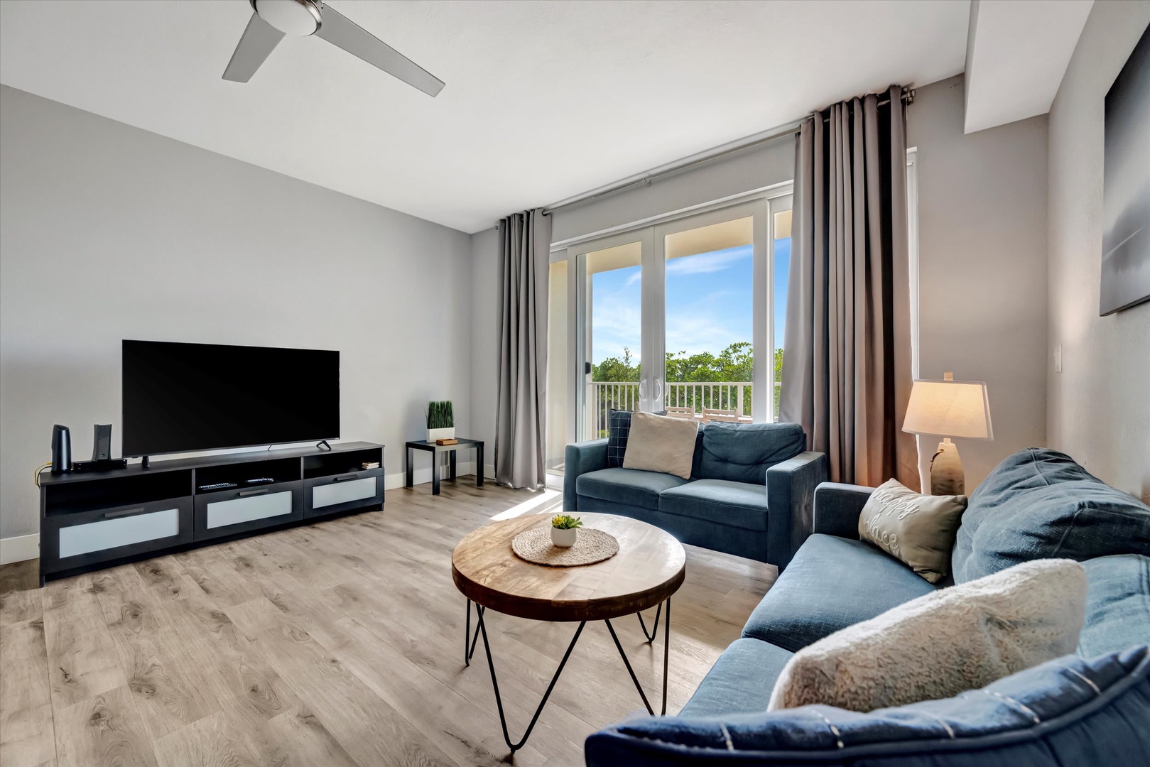 Settle into this bright, modern living room where plush seating and natural light create your perfect relaxation spot. Enjoy the view from your private balcony after a day of exploring.