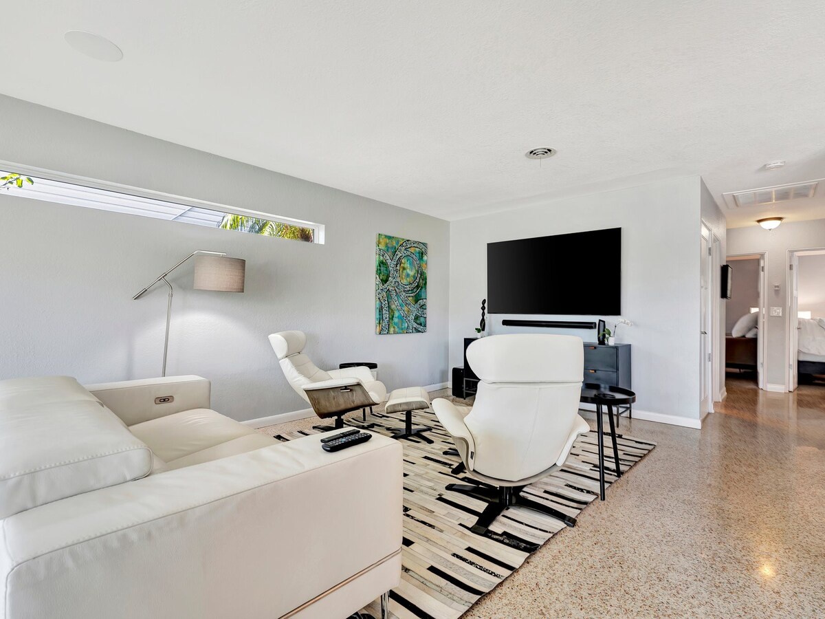 Settle into your sleek, light-filled living room with modern furnishings and an abundance of natural light streaming through the skylights, perfect for your downtime.