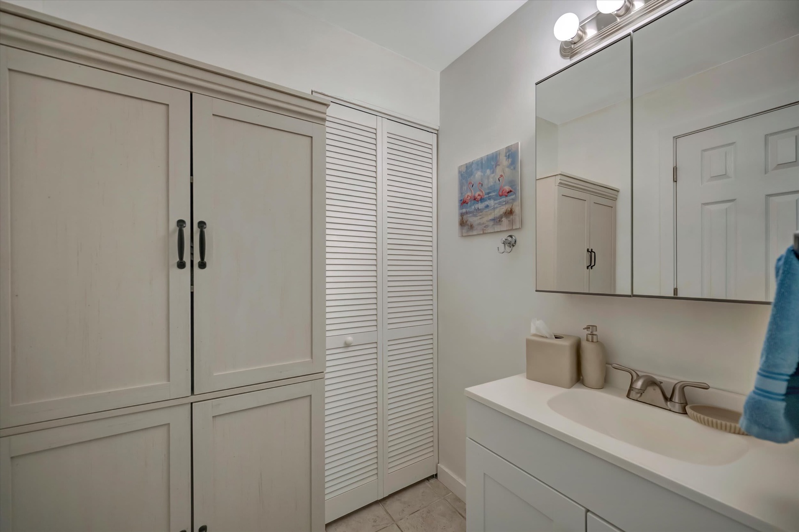 Step into your pristine coastal-inspired bathroom, where soft natural tones and crisp white cabinetry create a calm, spa-like retreat after a day of adventure.