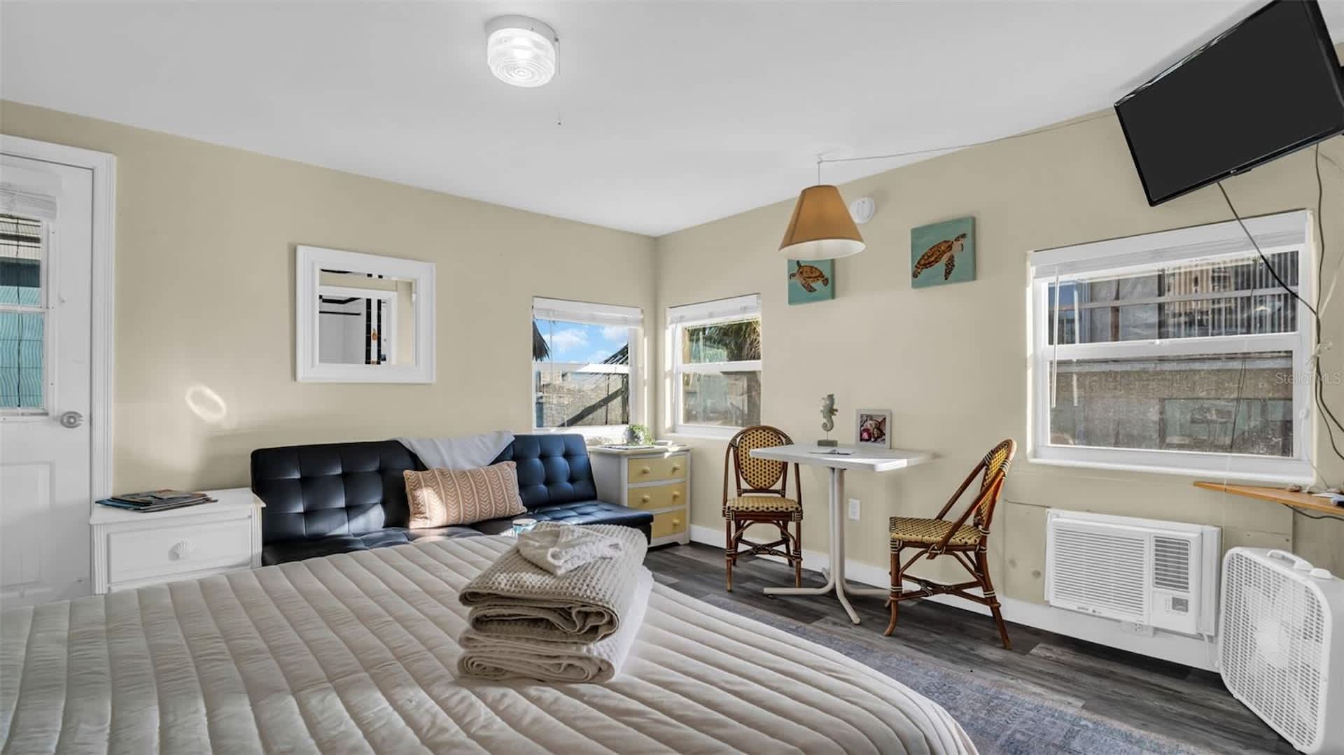 Unwind in your bright, beachy retreat with coastal decor, comfy seating, and natural light streaming through the windows—everything you need to feel right at home.