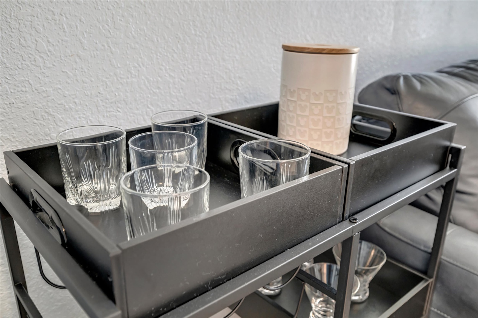 Your welcoming station awaits with fresh glassware and a stylish canister, ready for you to settle in and enjoy your first refreshing drink.
