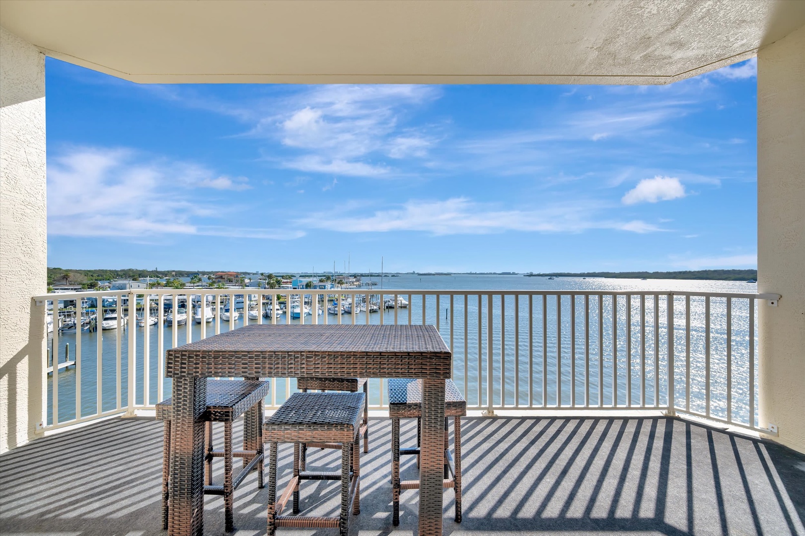 Your private balcony overlooks a sparkling marina, where gentle waters stretch to the horizon. Sip morning coffee at your outdoor table while sailboats drift by and sunshine dances on the bay.