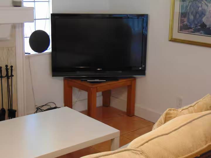 Settle in for your favorite shows on the large flat-screen TV. This cozy living space is perfect for unwinding with soft seating and a bright, welcoming atmosphere.
