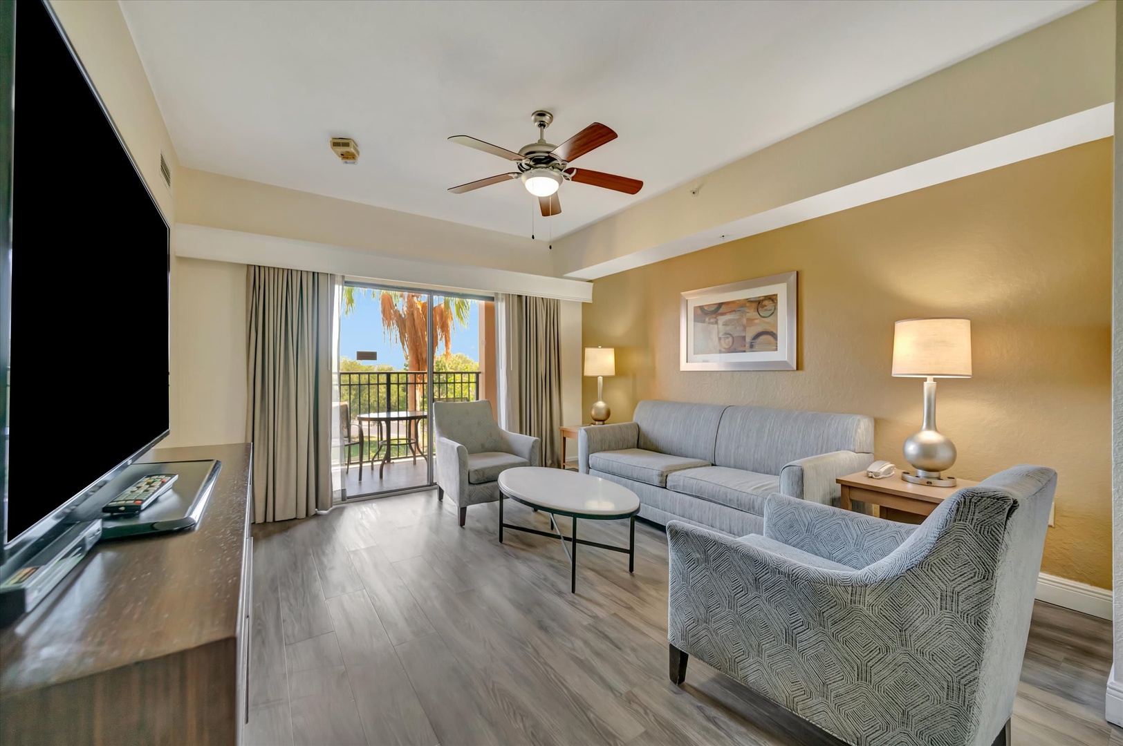 Sink into plush seating and let the gentle breeze from your private balcony refresh your senses. With sunlit views and cozy furnishings, this inviting living space is your perfect retreat after a day of adventure.