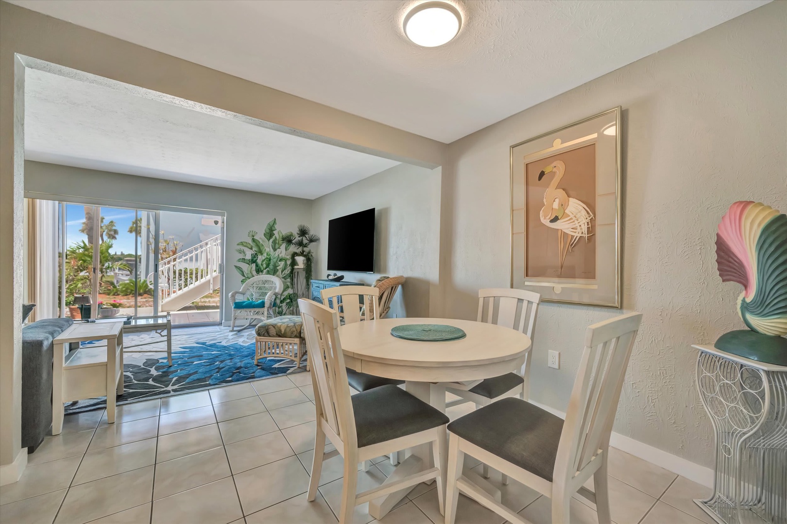Relax and dine in your bright, coastal-style space where the open layout flows from dining to living room. Tropical vibes and beachy decor make every moment feel like a getaway.