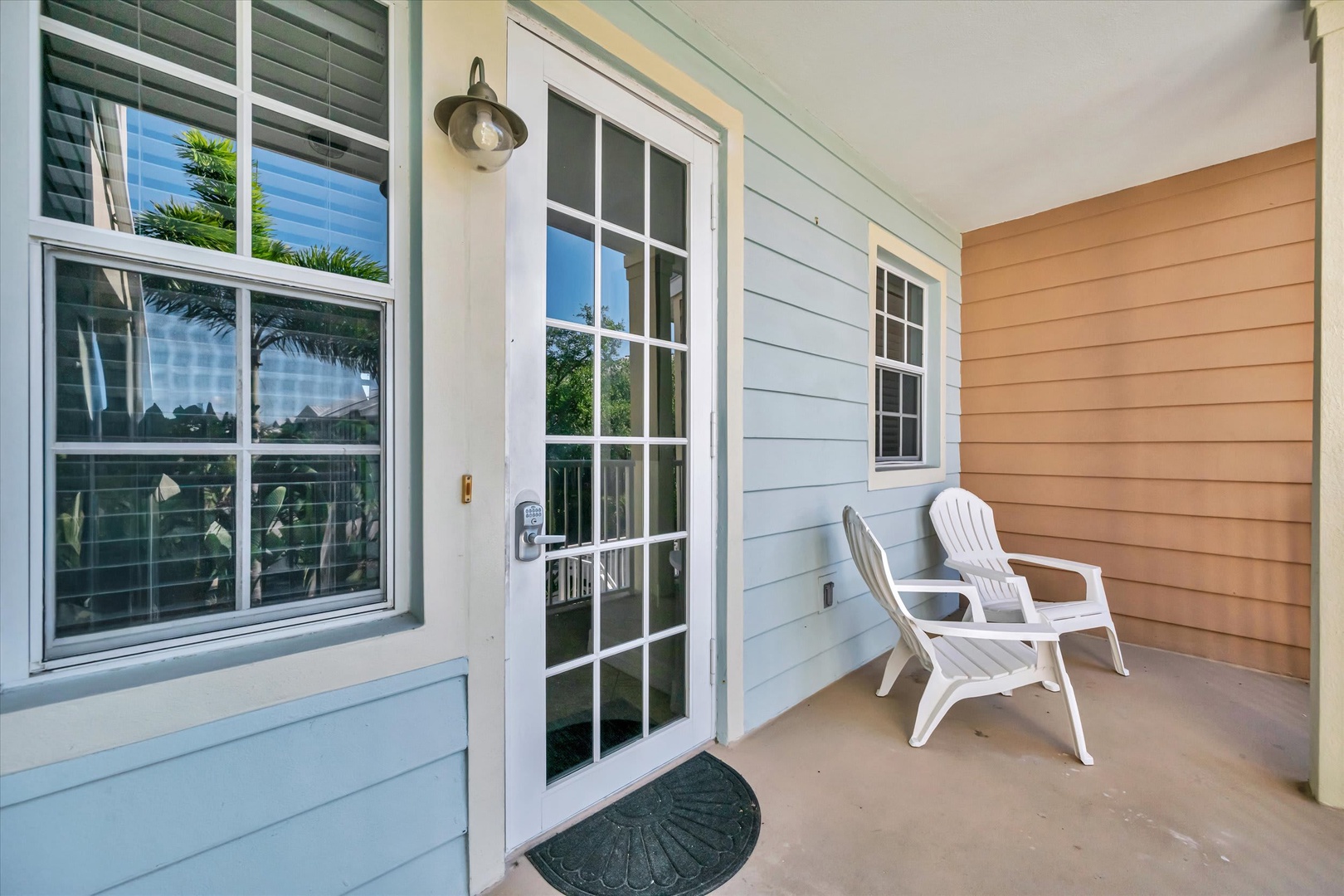 Your private entryway sets a welcoming tone with a charming glass door and cozy seating, inviting you to settle in and unwind.