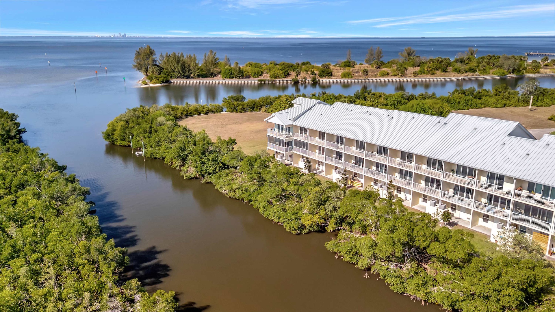 Waterfront property surrounded by natural mangroves and calm bay waters, offering a serene coastal retreat with direct water access.