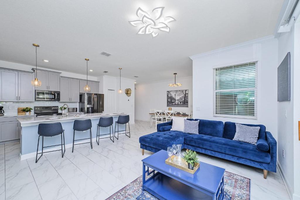 Relax in your bright, open-concept living area with a modern kitchen island for easy meals and a plush velvet sofa for unwinding after a day of exploring.