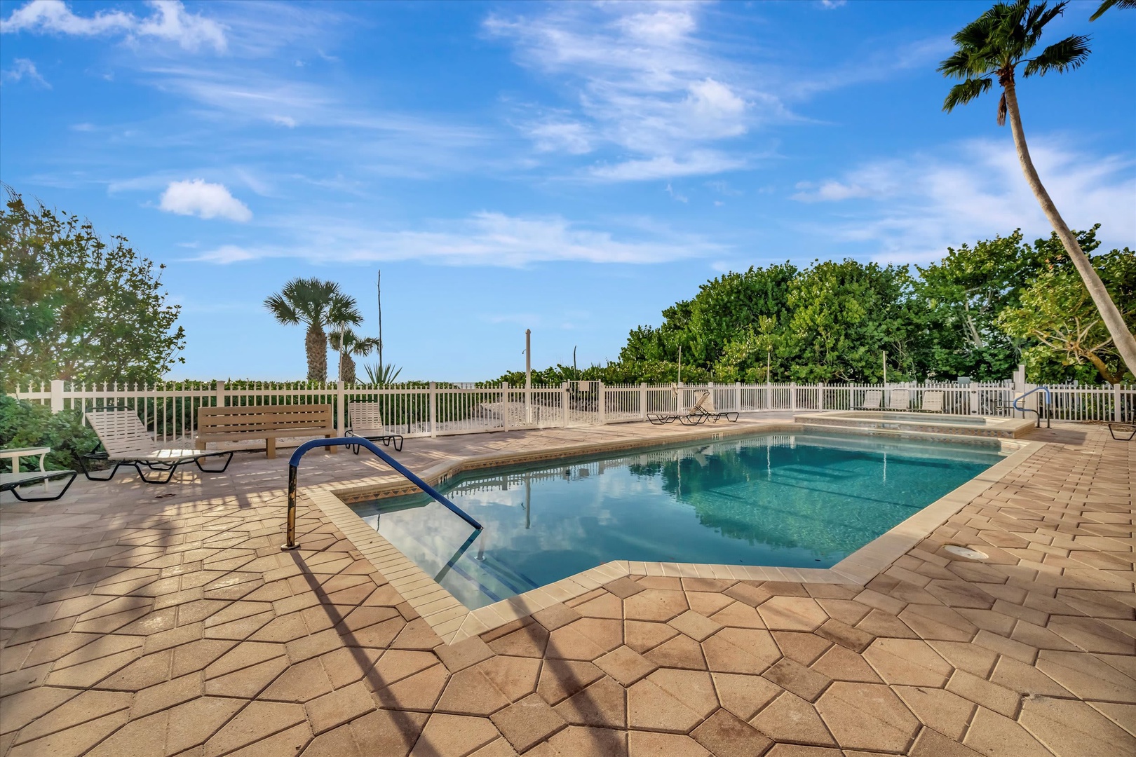 Picture yourself lounging poolside under swaying palms, the Florida sunshine warming your skin. This sparkling oasis invites you to unwind and soak up the tropical atmosphere in your own private paradise.