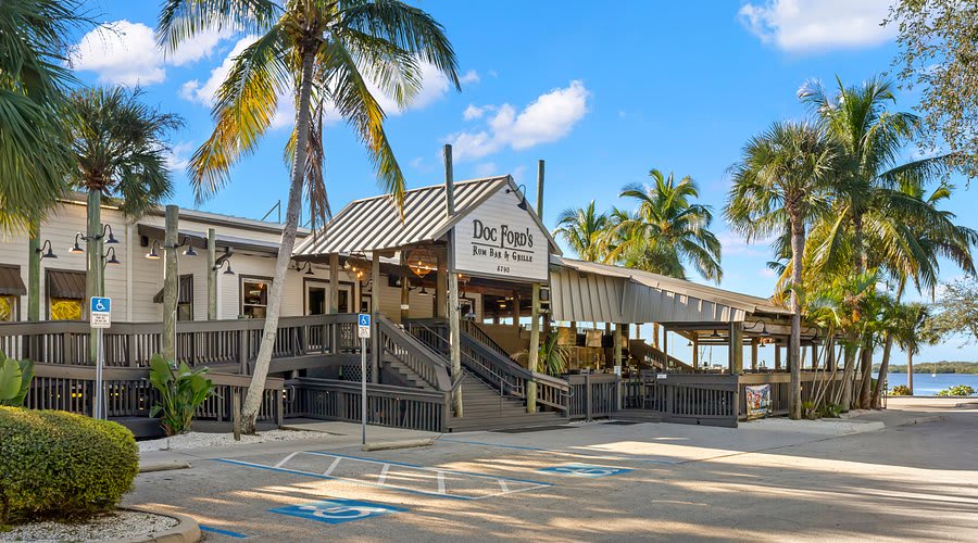 Doc Ford's Rum Bar & Grille sits waterside, framed by swaying palms and island charm, inviting you to unwind with fresh catches and tropical cocktails.