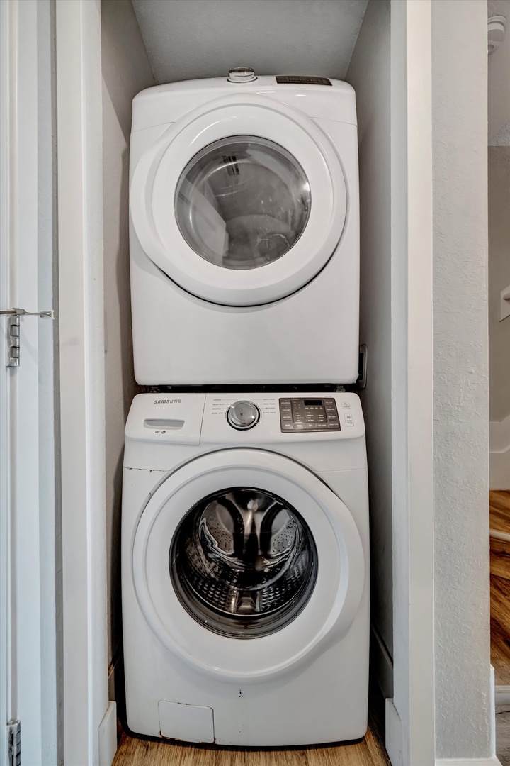 A modern, compact laundry setup—washer and dryer stacked neatly in a dedicated closet, ready whenever you need them.