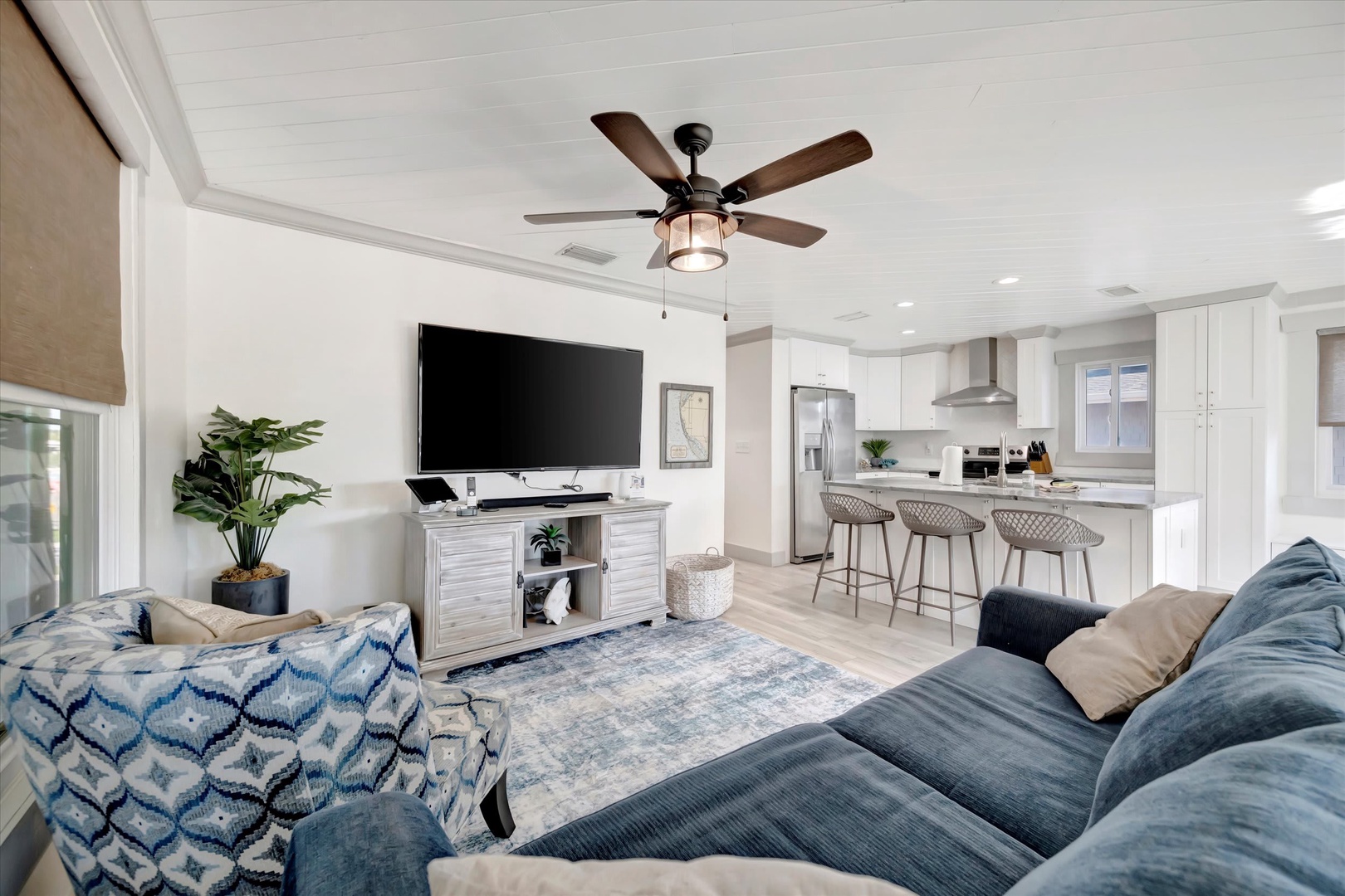 Sink into plush seating in your bright, open-concept living space where coastal-chic style meets modern comfort. The fully-equipped kitchen invites you to whip up your favorite meals.