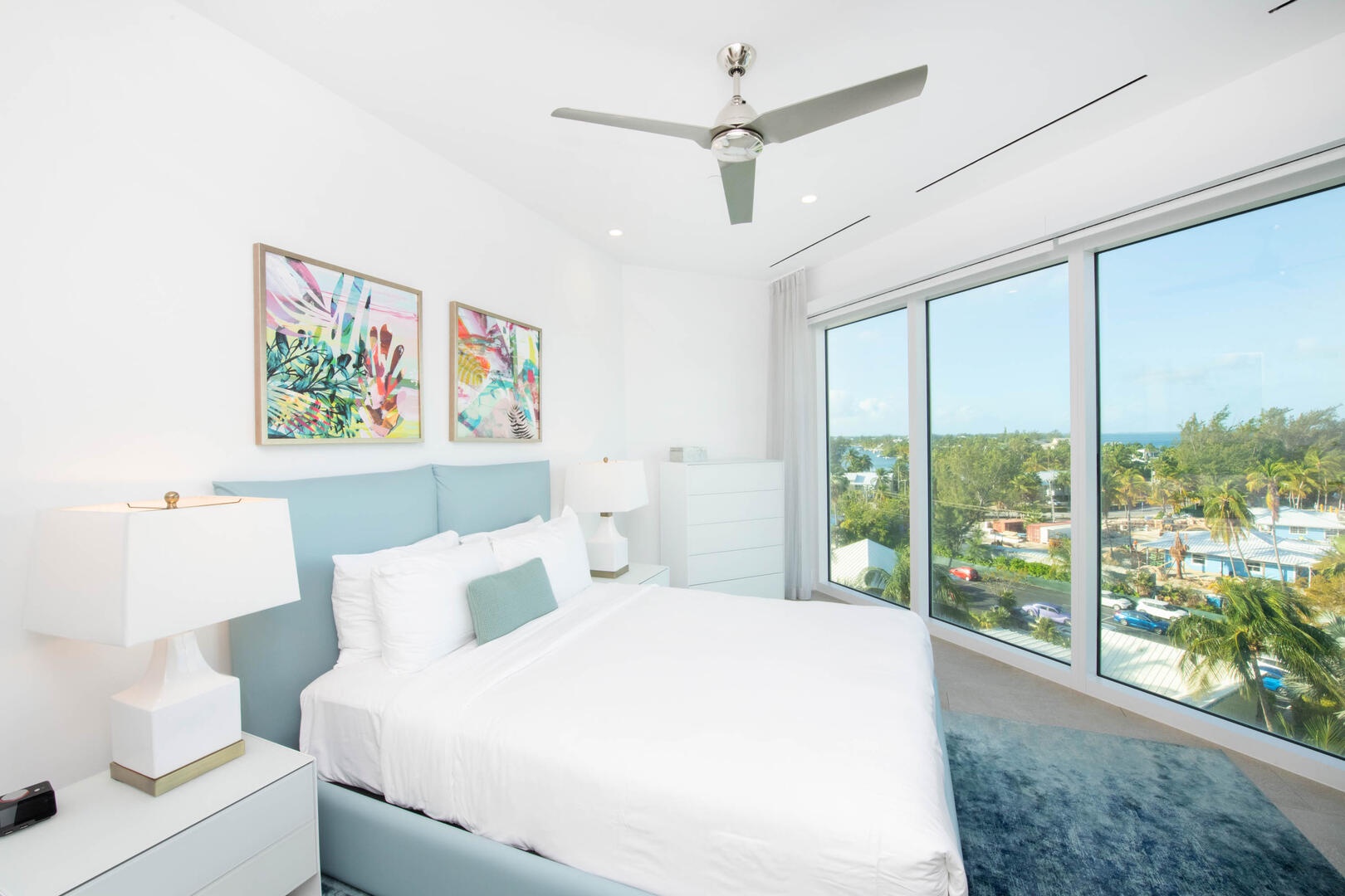 Guest Suite #2 with elevated island views, queen bed, and a SmartTV.