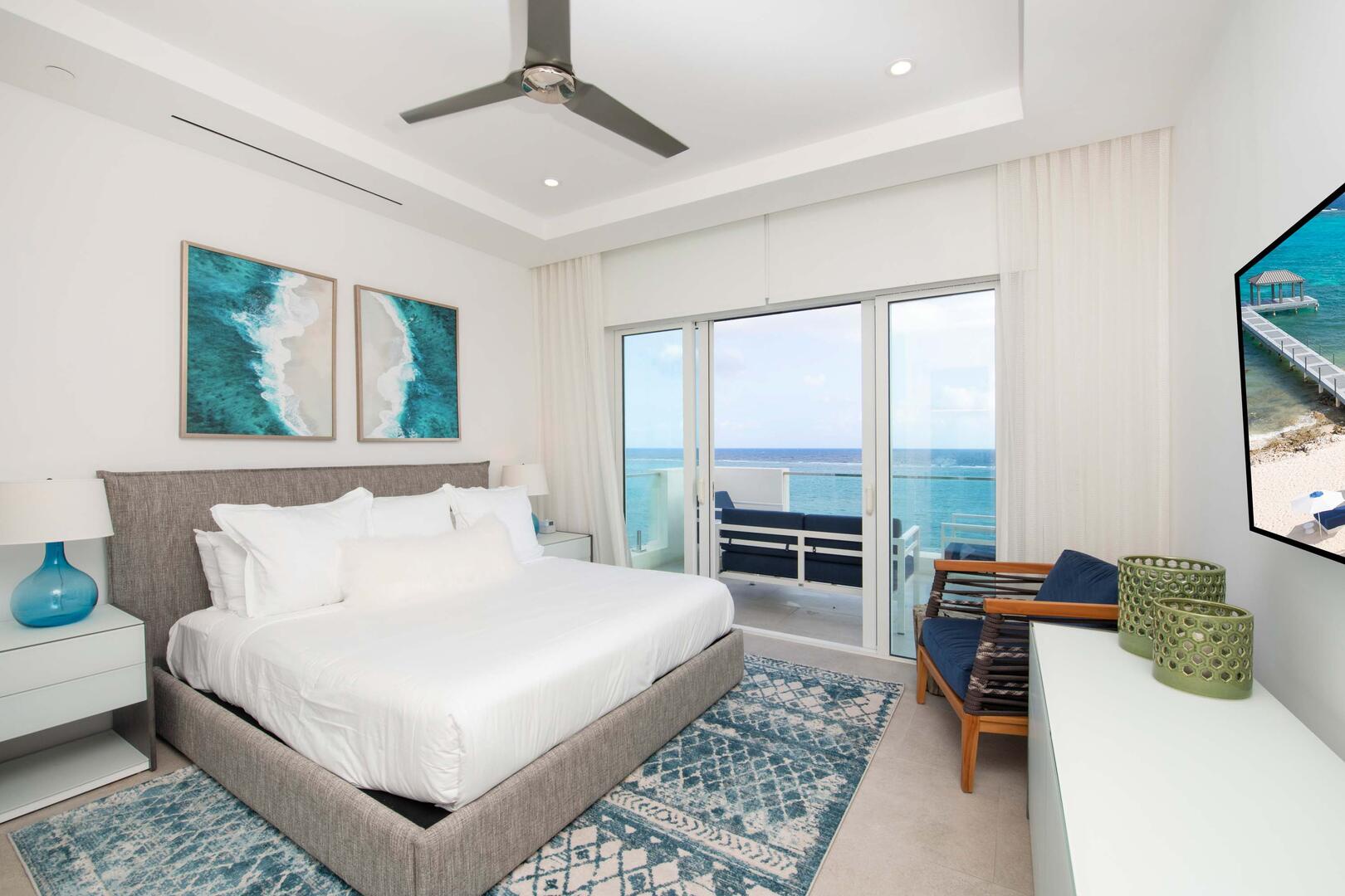 Primary Suite 1: king bed, ocean views, walk-out access to the open-air balcony, SmartTV, walk-in closet, ensuite bath with soaking tub, and walk-in shower.