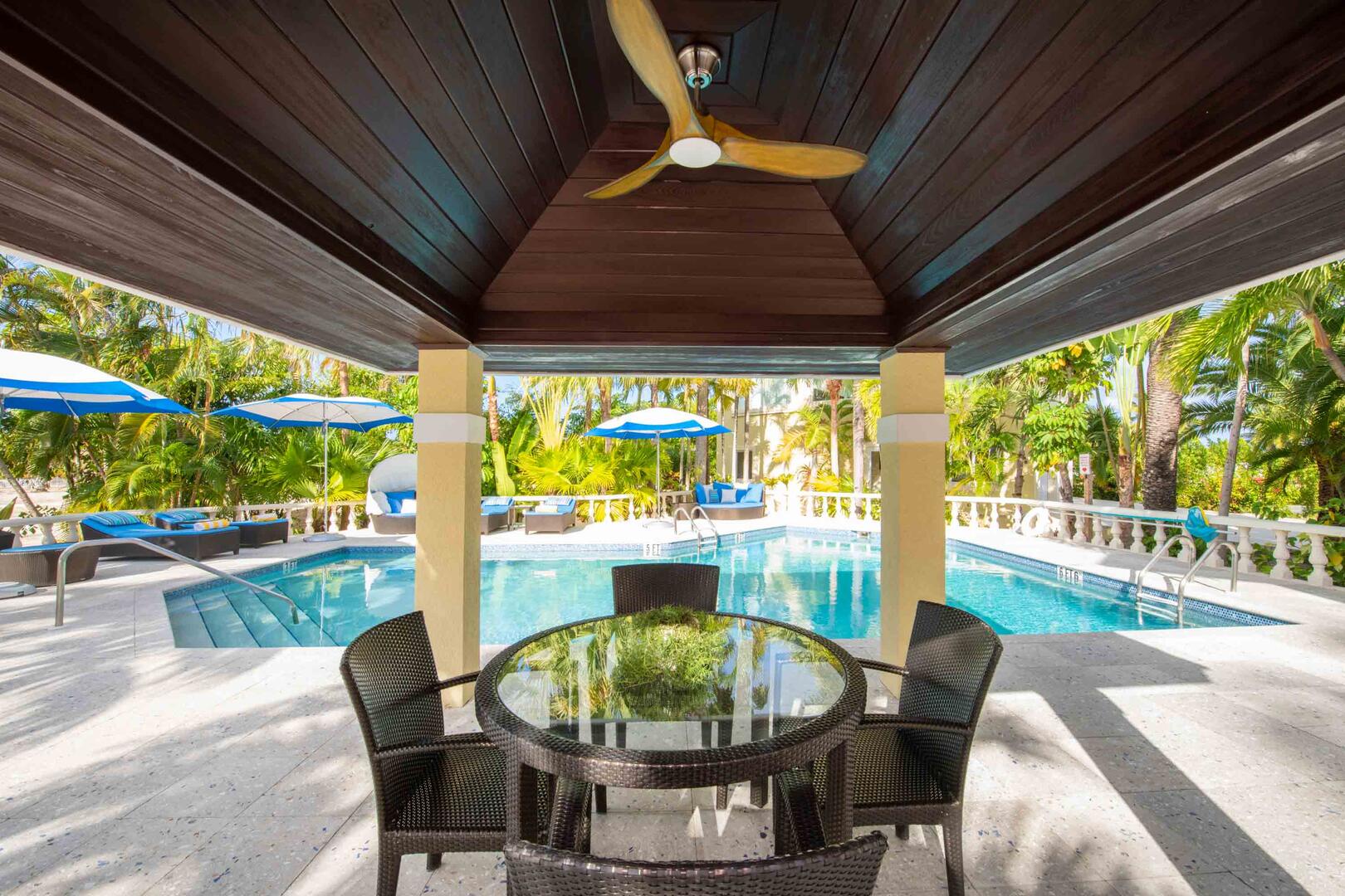 Large pool deck with dining cabana.