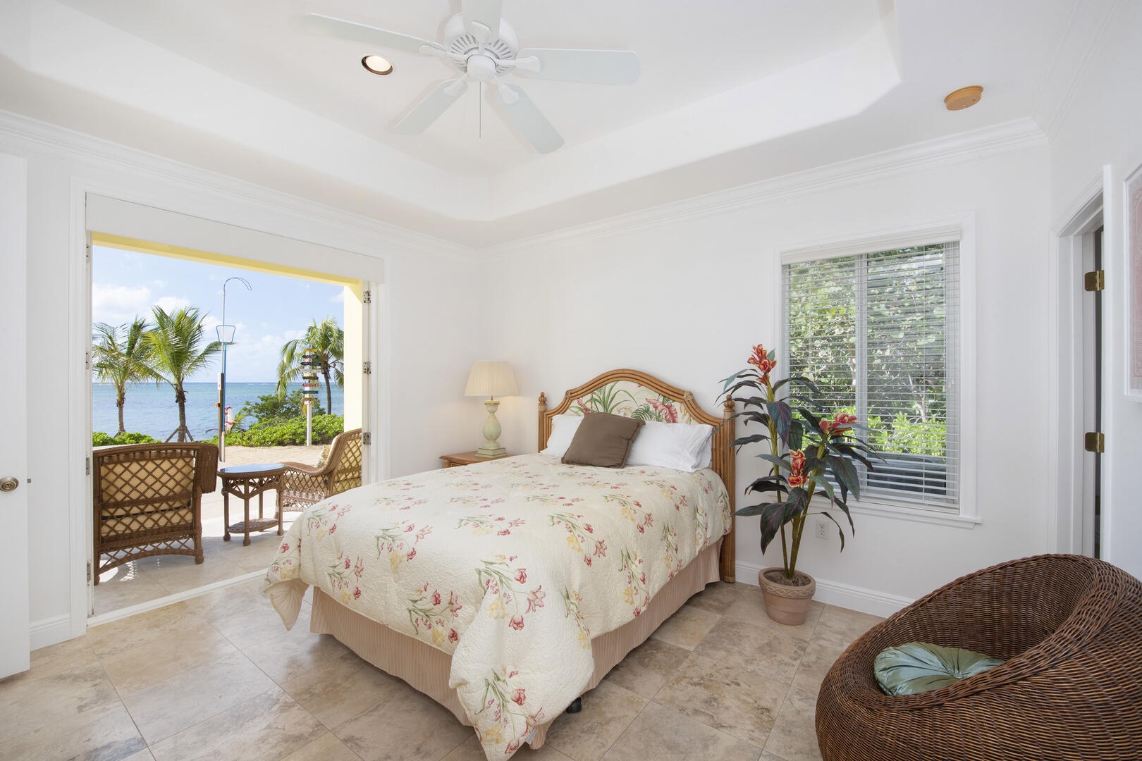 Bedroom 1 on the lower level with queen bed and walk-out access to the pool deck.