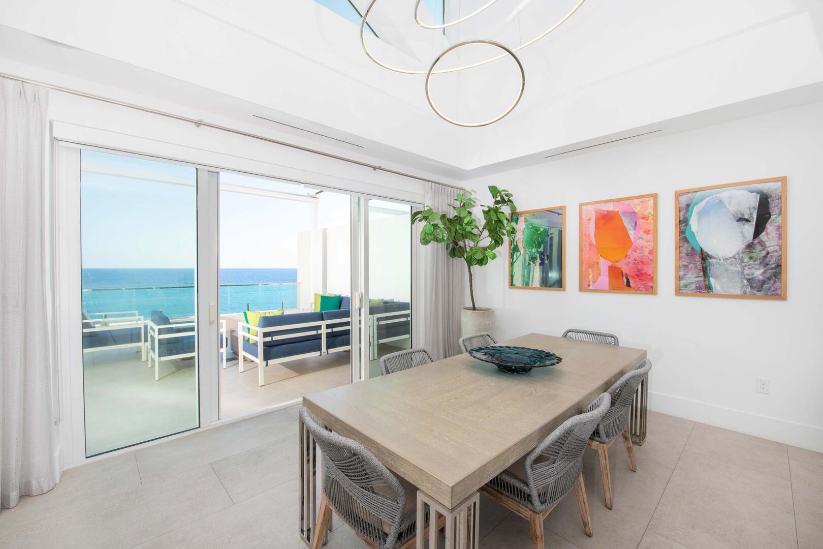 Formal indoor dining table with walk-out access to the furnished penthouse balcony. Enjoy meals with views that will leave you breathless.