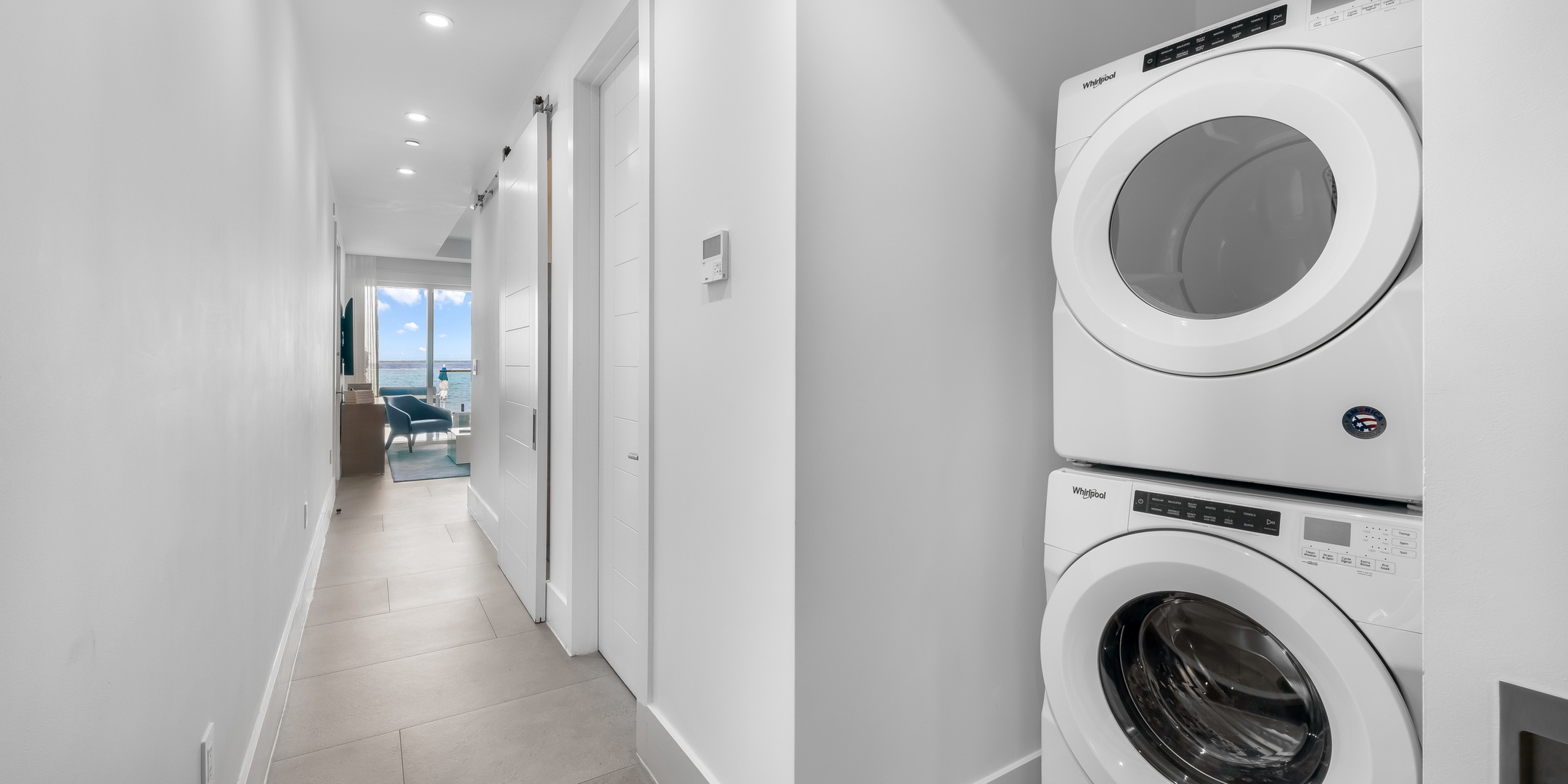 In-unit laundry room with staked washer and dryer.