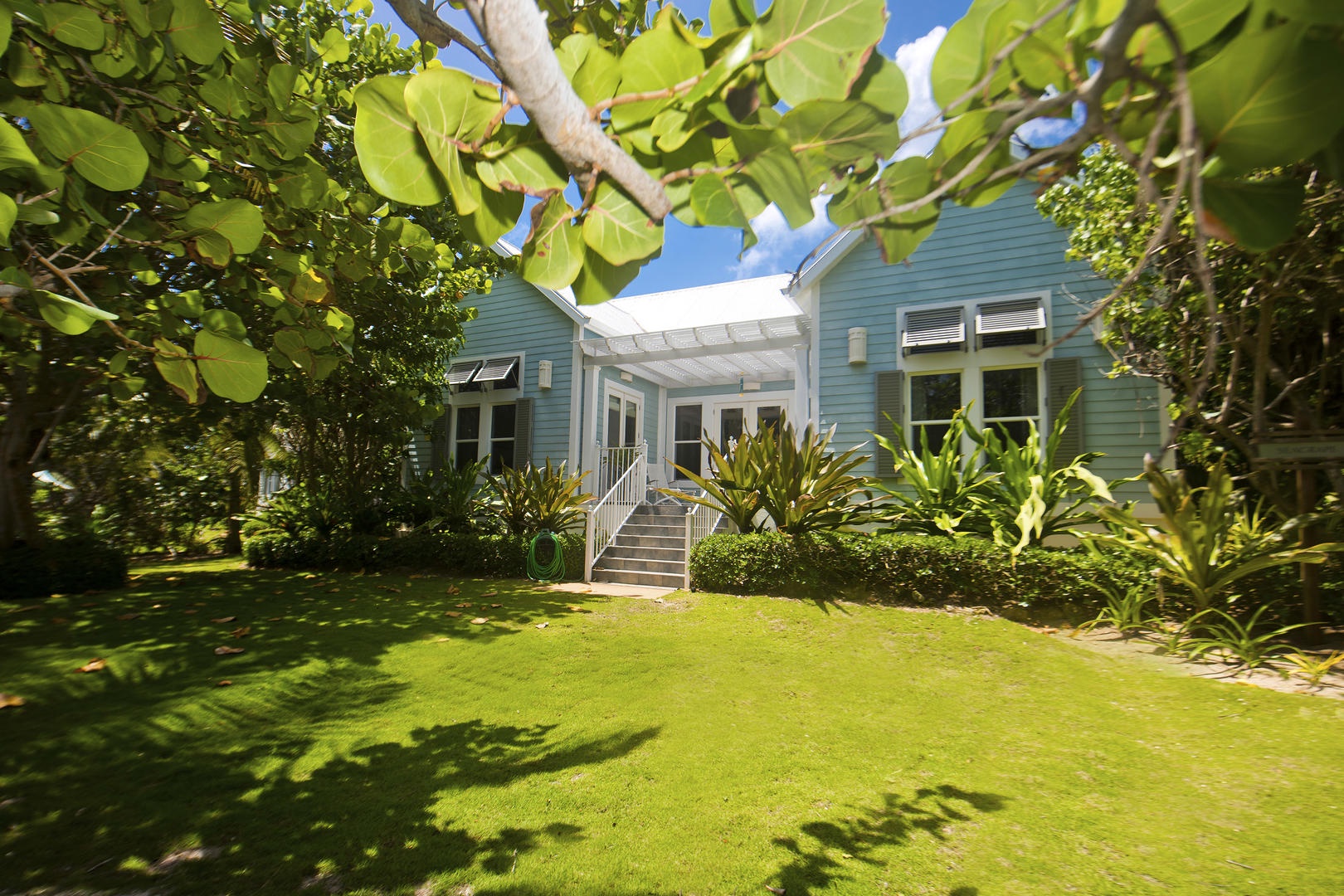 Mango Cottage's exterior has a bright beach bungalow look to it.