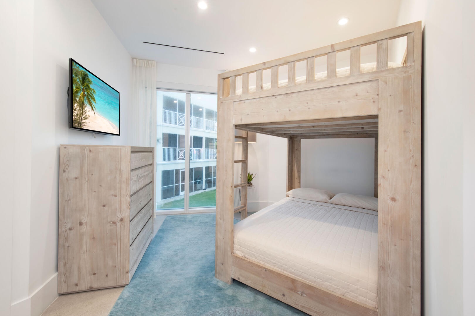 Bunk suite with full-over-full bunk beds and television.