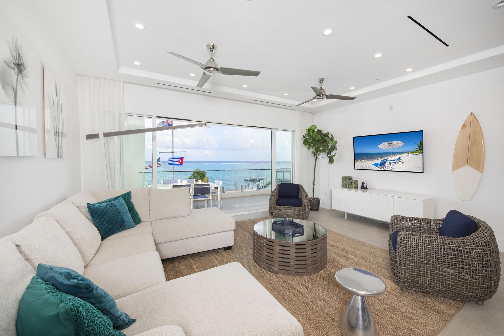 Living area with plush sectional sofa, SmartTV, and coastal decor.