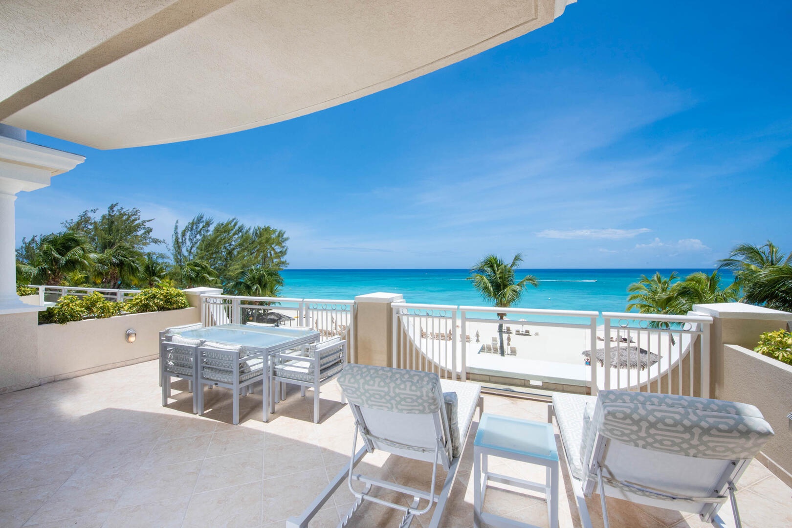 Furnished balcony with seats and tables.