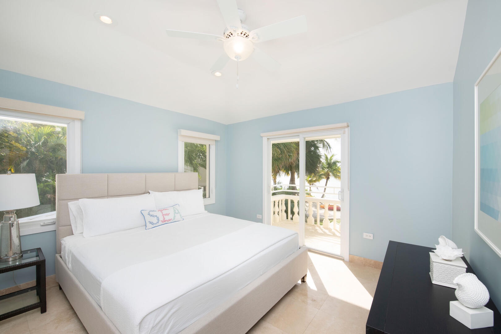 Guest Bedroom #1 with queen bed and a private waterfront balcony.