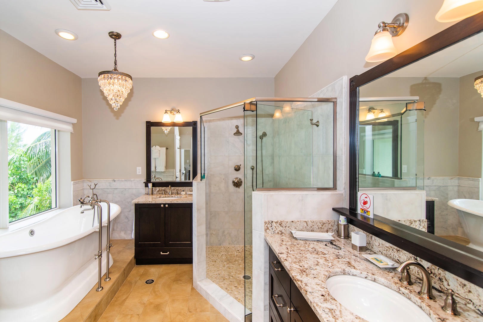 Master ensuite bath with soaking tub, glass shower, and double vanity.