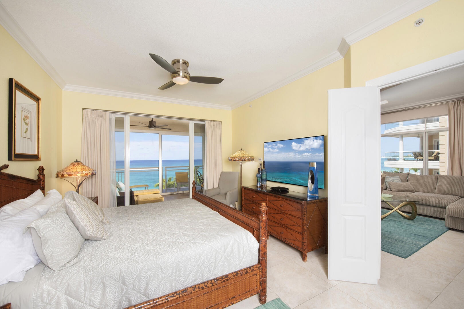 Primary suite with king bed and walk-out access to the screened balcony.