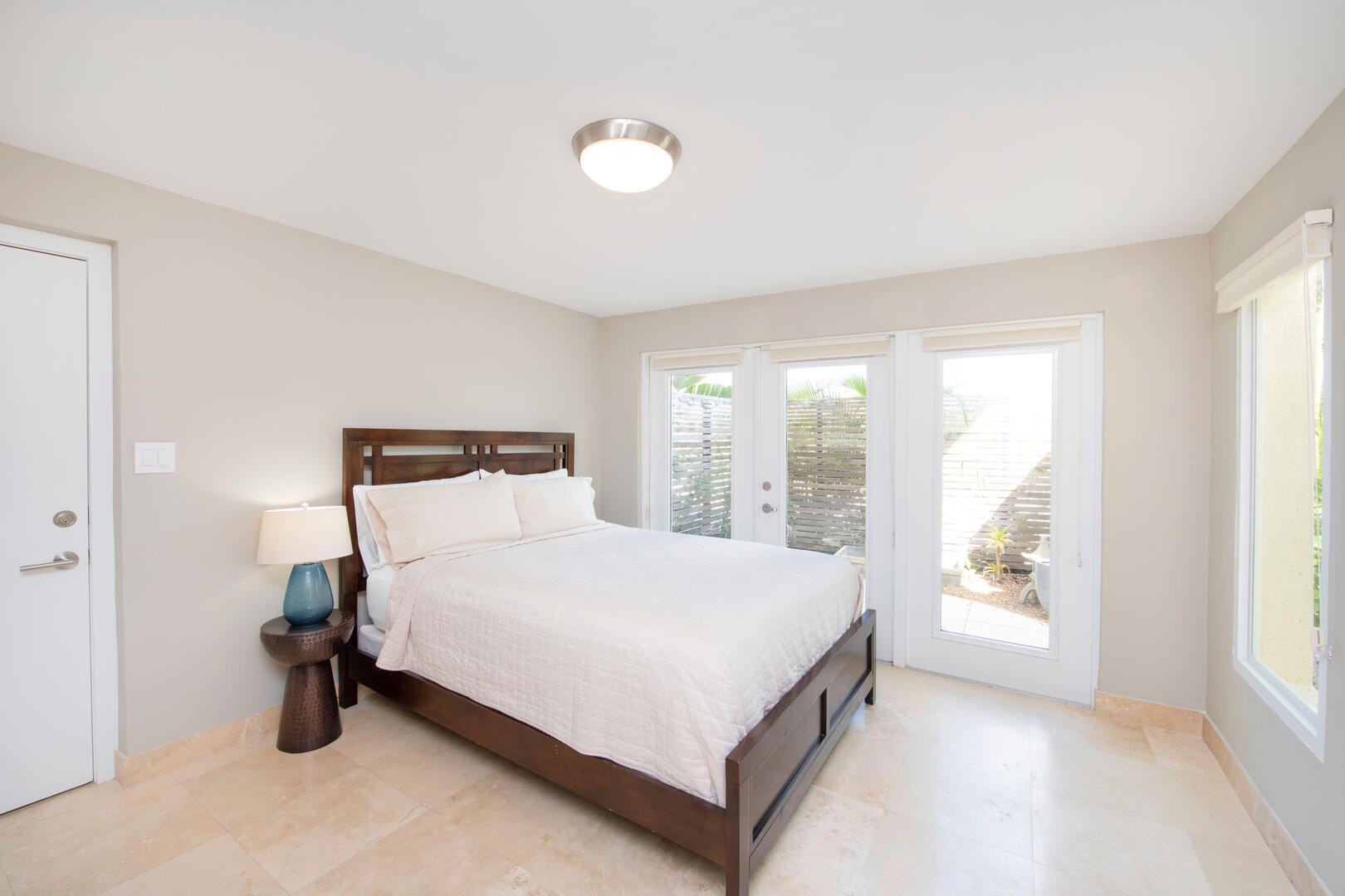 Zen Suite with queen bed and walk-out access to a small zen garden.