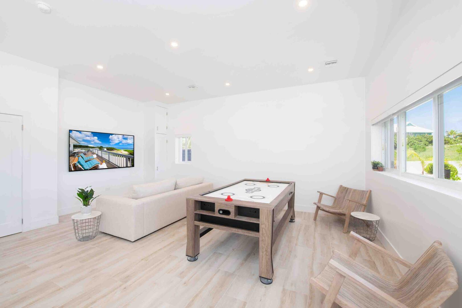 Lower level den and game room with a 3-in-1 game table for air hockey, ping pong, and pool.