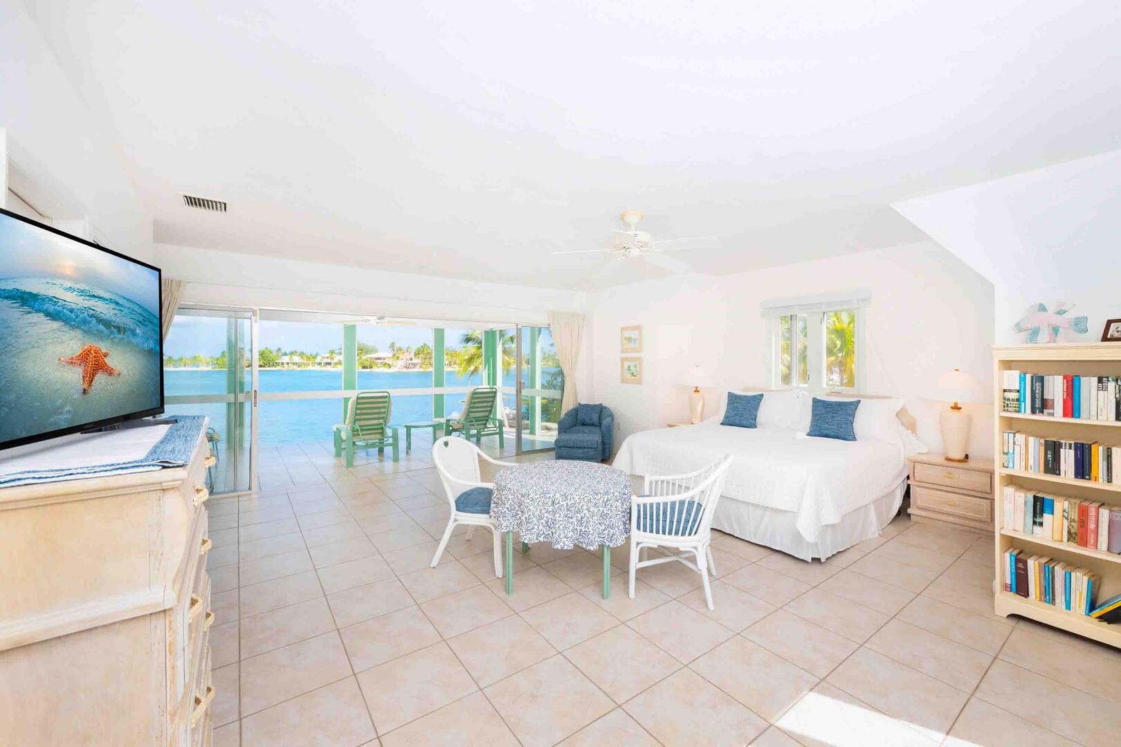 Bedroom 1 is the primary suite on the upper level with a king bed, HD television, and a private waterfront balcony.