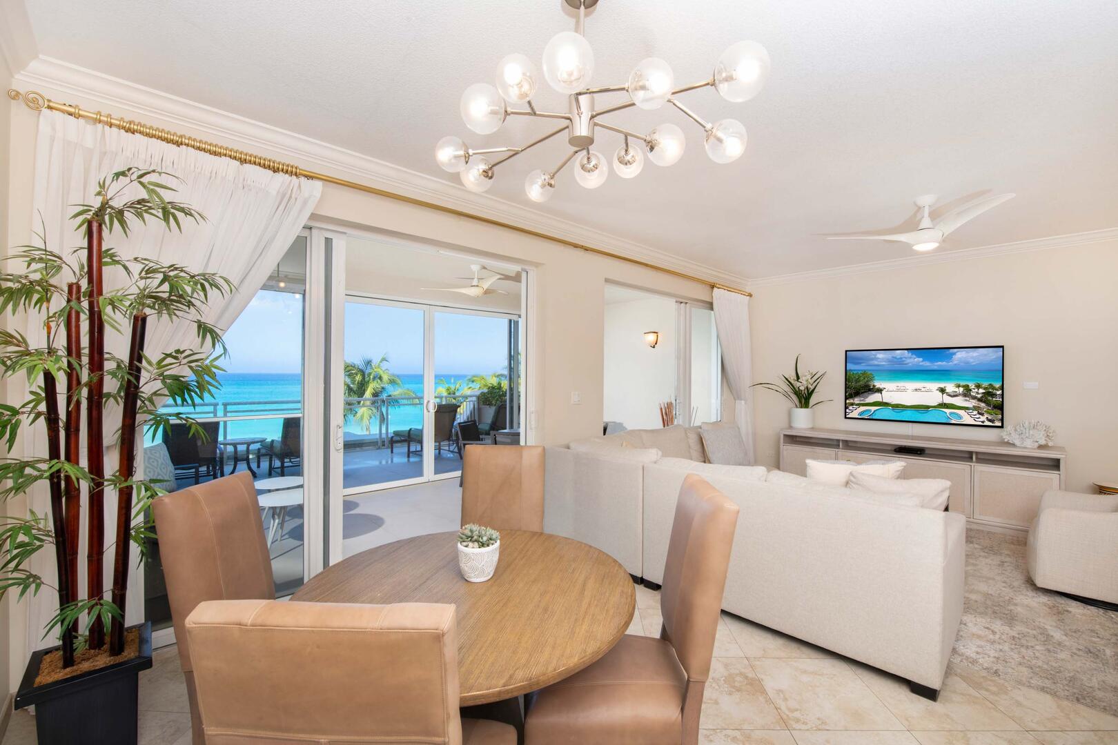 Living area furnished with a sectional sofa, small dining table, and cable HD TV.